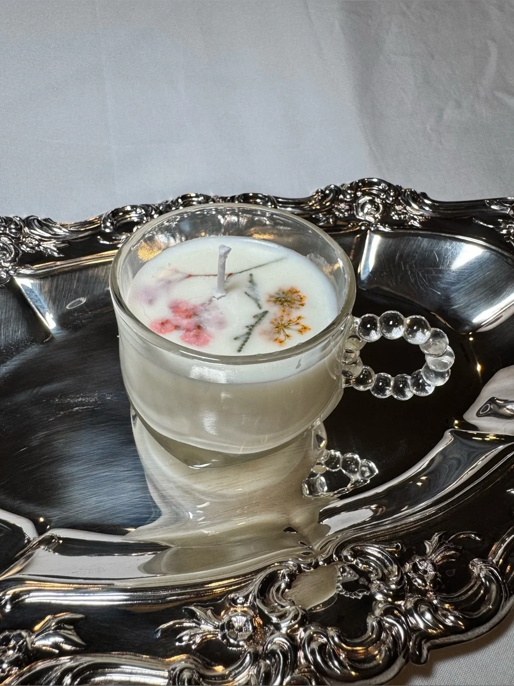 White Floral Teacup Candle in Clear Glass Cup with Beaded Handle
